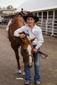 Cheyenne Allen standing next to horse