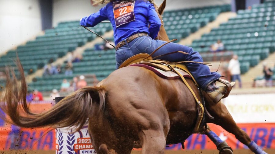 girl on a barrel horse turning a barrel. Photo by Tammy Sronce