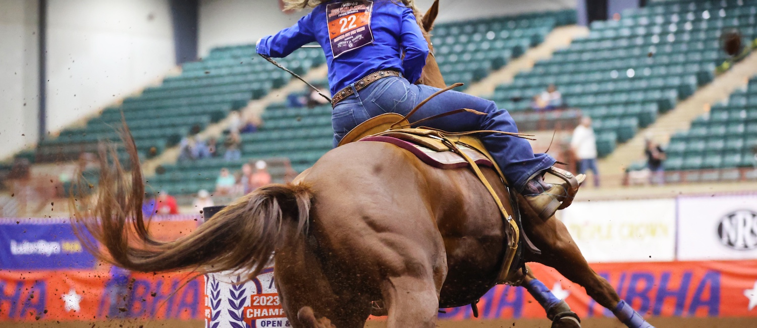 girl on a barrel horse turning a barrel. Photo by Tammy Sronce