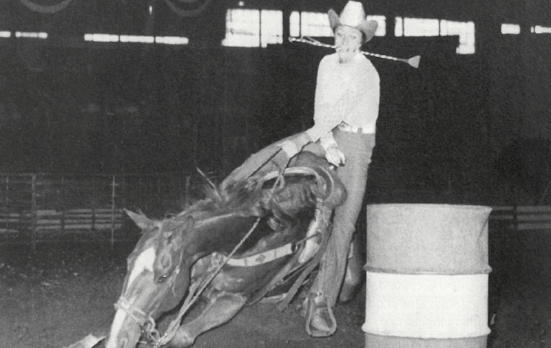 Kay Young riding horse Tiger around the barrel