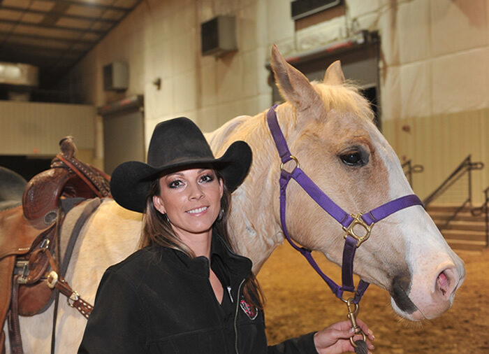 Kassie Mowry standing with futurity horse