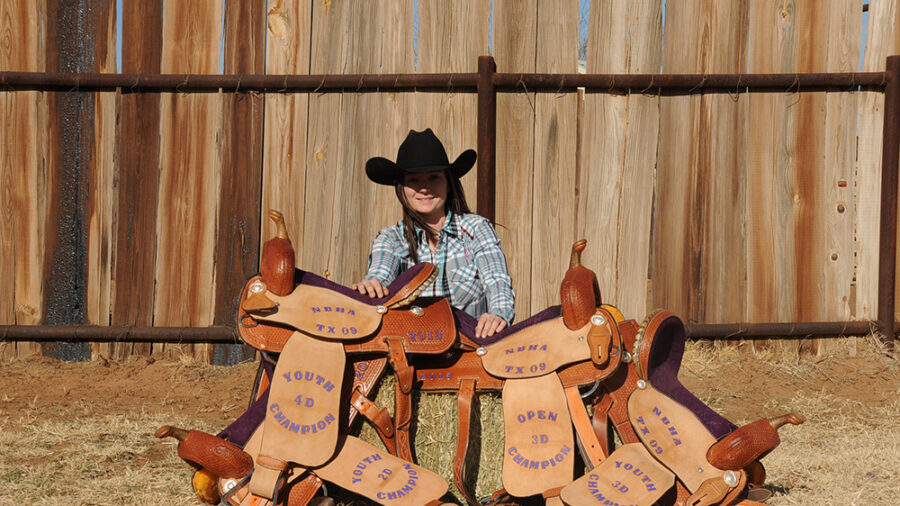 Since her first ride on Little Red, Melissa has come a long way - and she isn't slowing down! She is pictured with the saddles she won on Tequila, Cookie, and Tejas during her first year in the NBHA. Photo by Kay Eppenauer.
