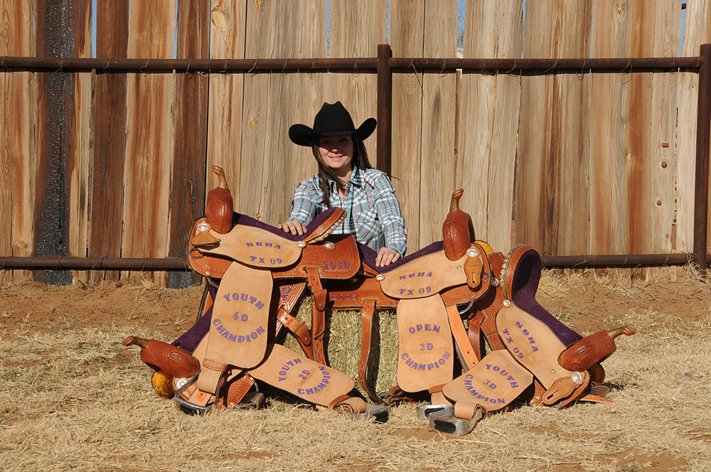 Since her first ride on Little Red, Melissa has come a long way - and she isn't slowing down! She is pictured with the saddles she won on Tequila, Cookie, and Tejas during her first year in the NBHA. Photo by Kay Eppenauer.