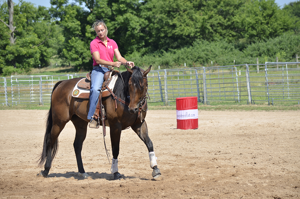 As Janna circles the first barrel, she focuses on the body position of both her and horse. She picks her horse’s shoulder up and uses her legs to keep her horse’s hips in position.