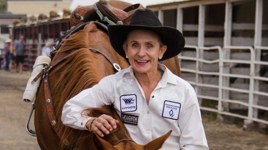 Cheyenne Allen standing next to horse