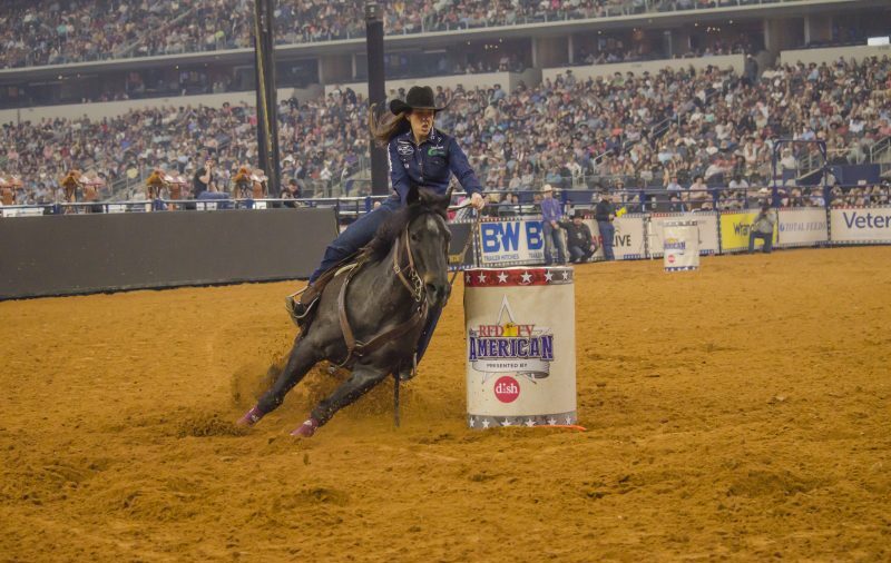 Nellie Miller and Rafter W Minnie Reba turn the third barrel at The American Rodeo