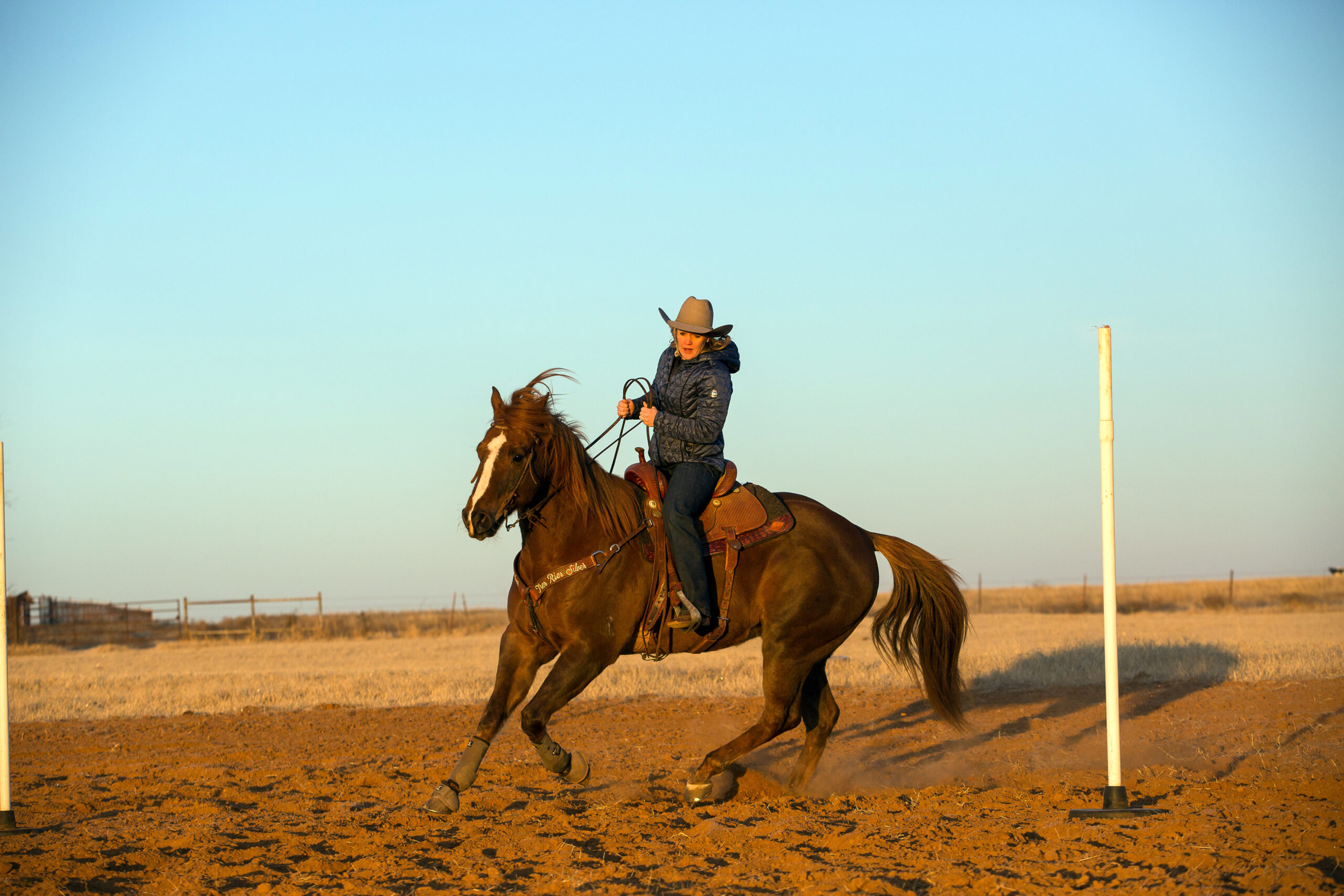 Kylie Weast trotting horse around pole