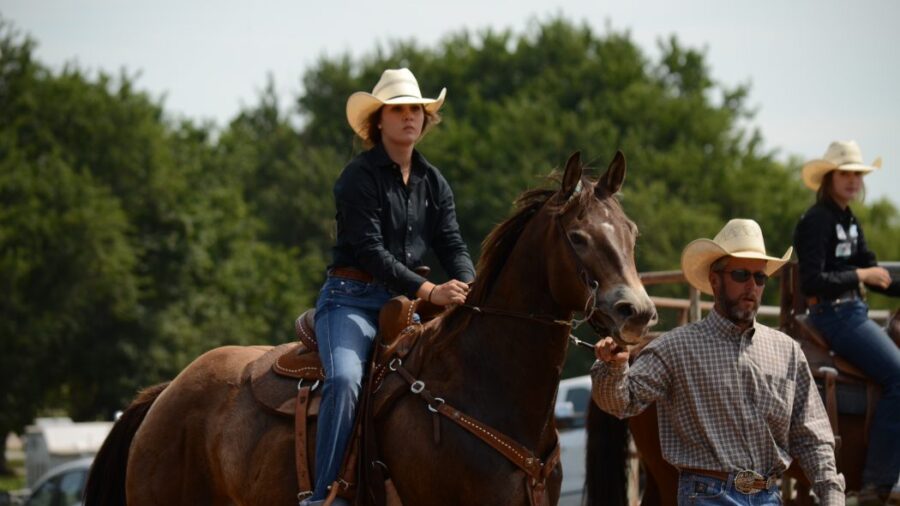 Dad leading daughter into arena