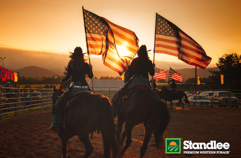 pivot setters carrying flags at a rodeo