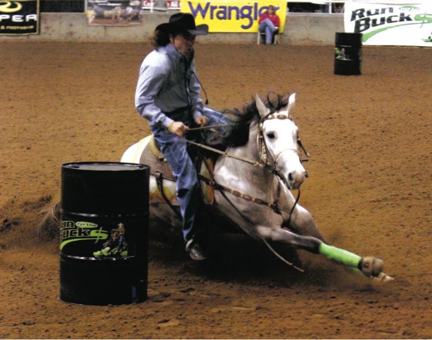 Lance Graves riding a horse in the barrels sold to him by Bo Hill