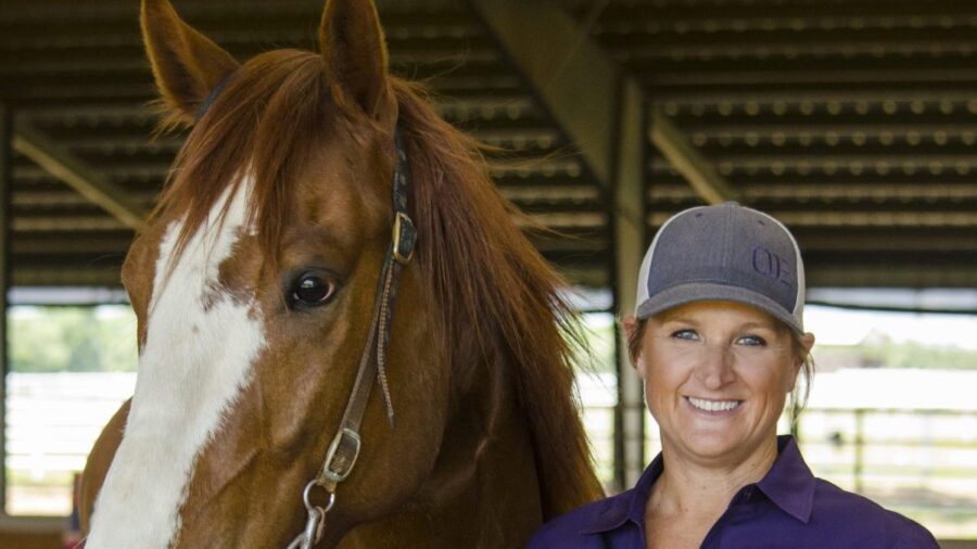 Ivy Hurst standing next to horse