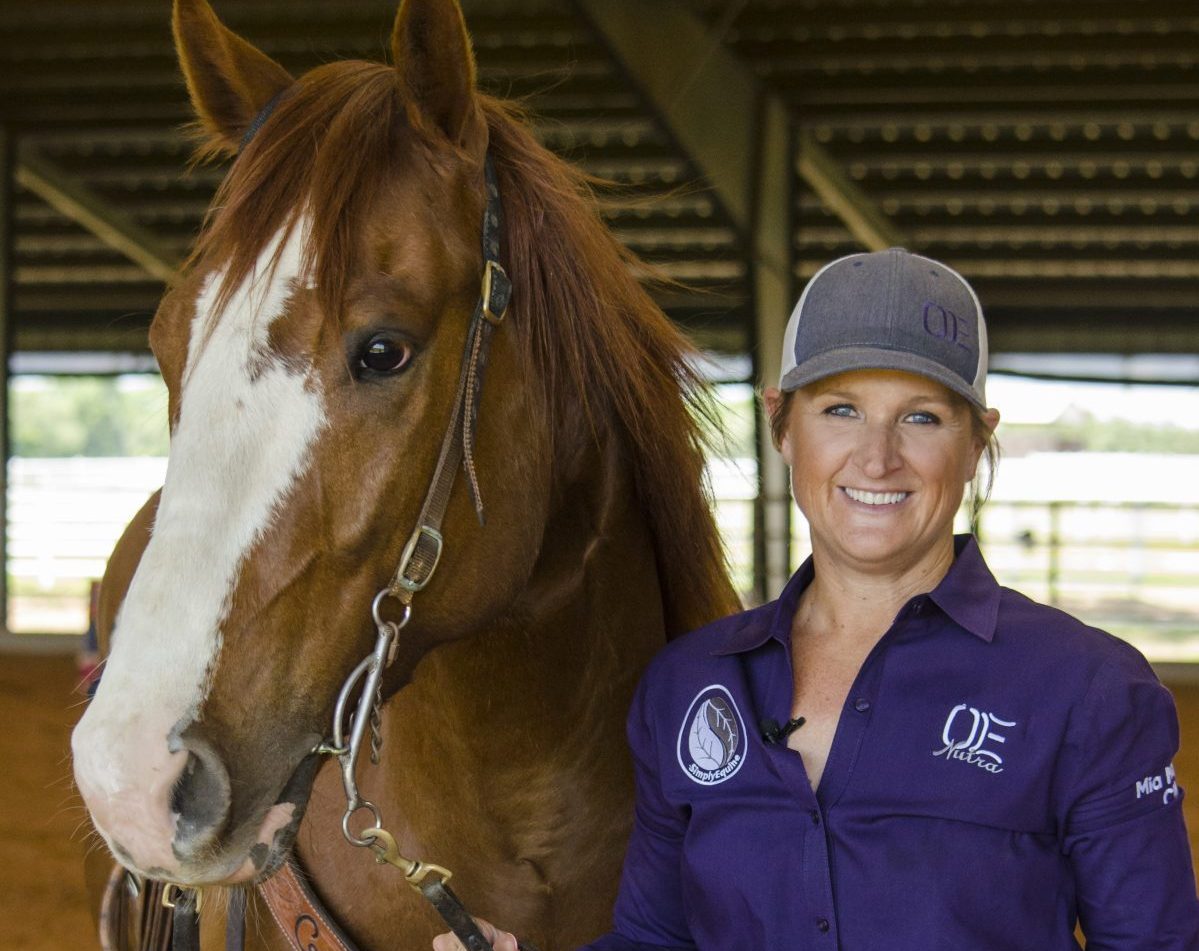 Ivy Hurst standing next to horse