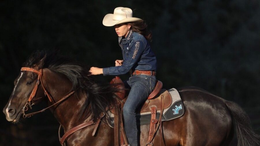 Nellie Miller riding Cowboy around a barrel
