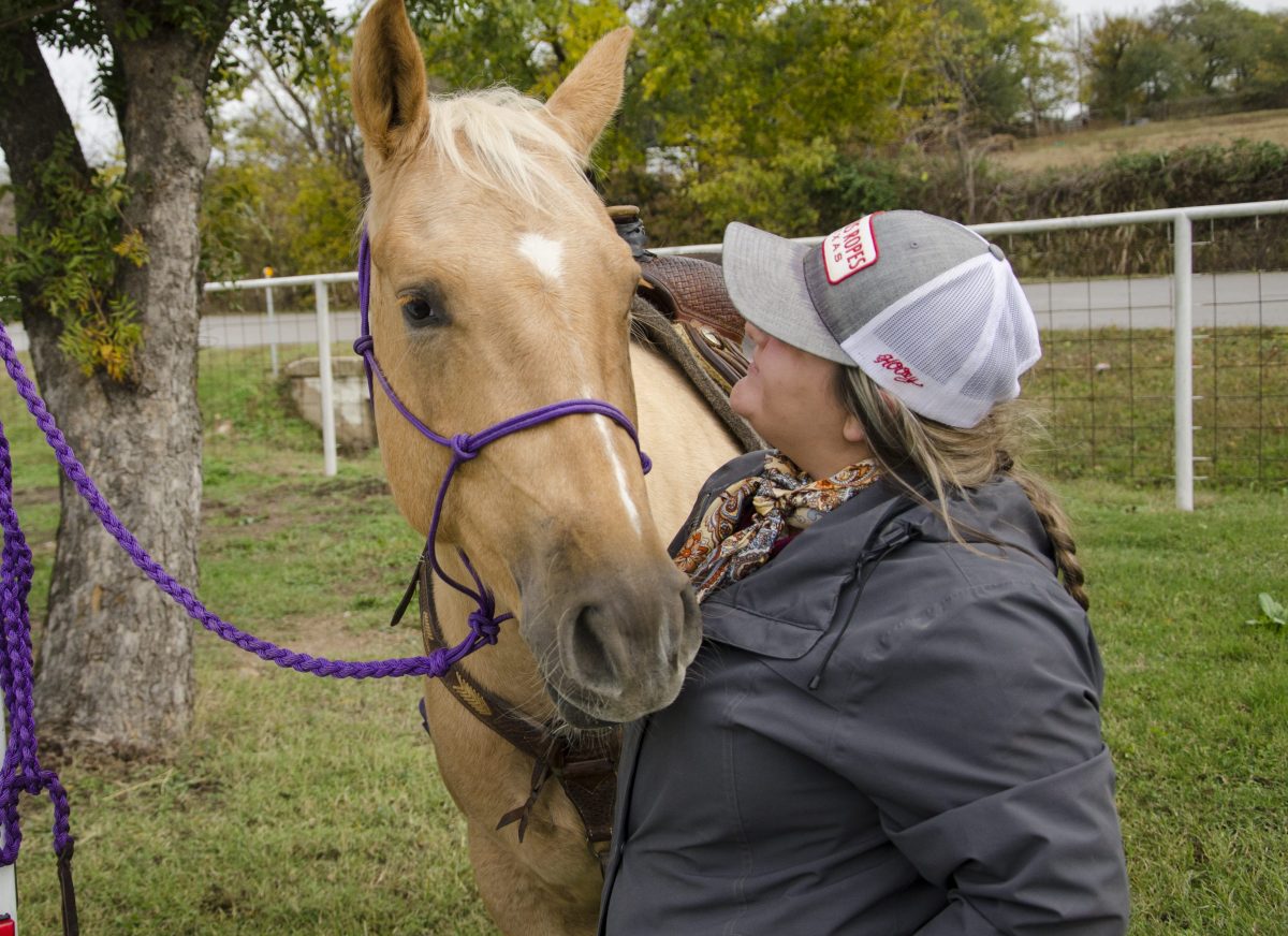 Kailey Sullins hugging horse's face