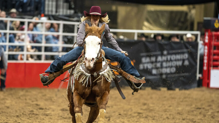 Brittney Barnett running into the arena at the San Antonio Stock Show Rodeo
