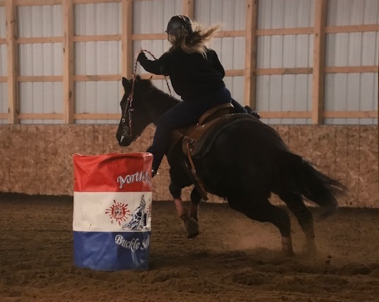 horse and rider leaving a barrel turn