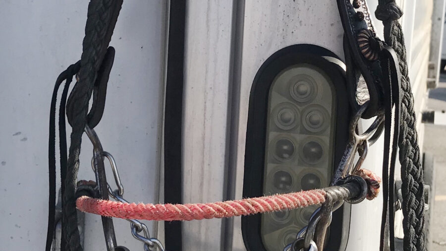 Troy Flaharty combination bit hanging against trailer