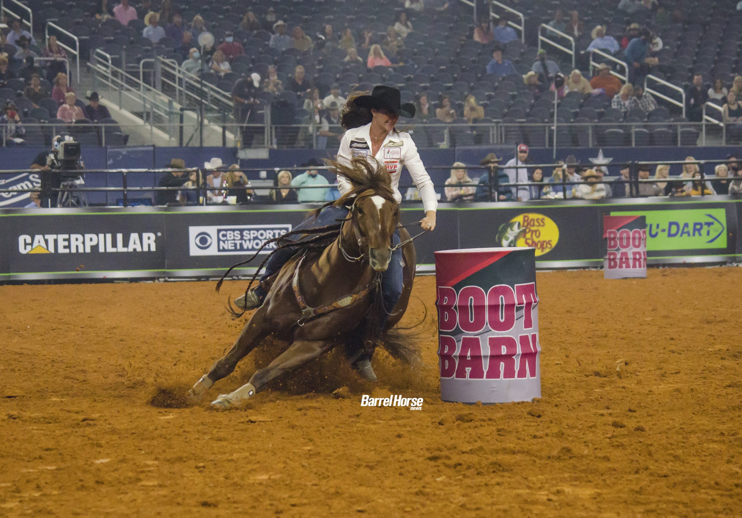 Hallie Hanssen and Tres Movidas turning a barrel at the Women's Rodeo World Championship