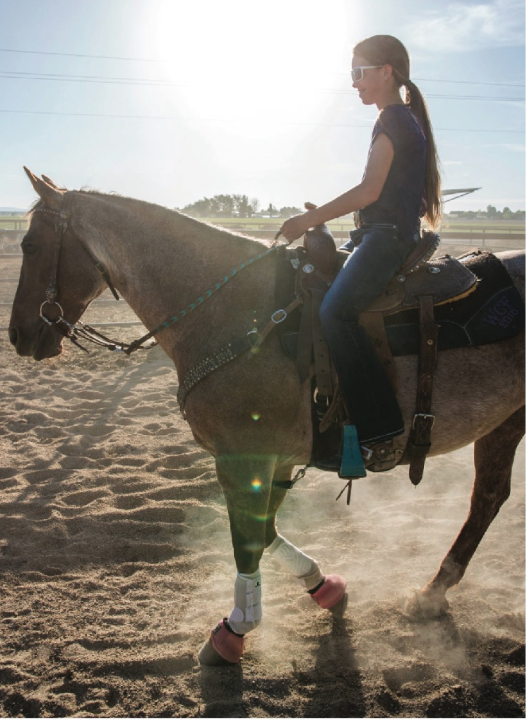 teenage girl riding horse