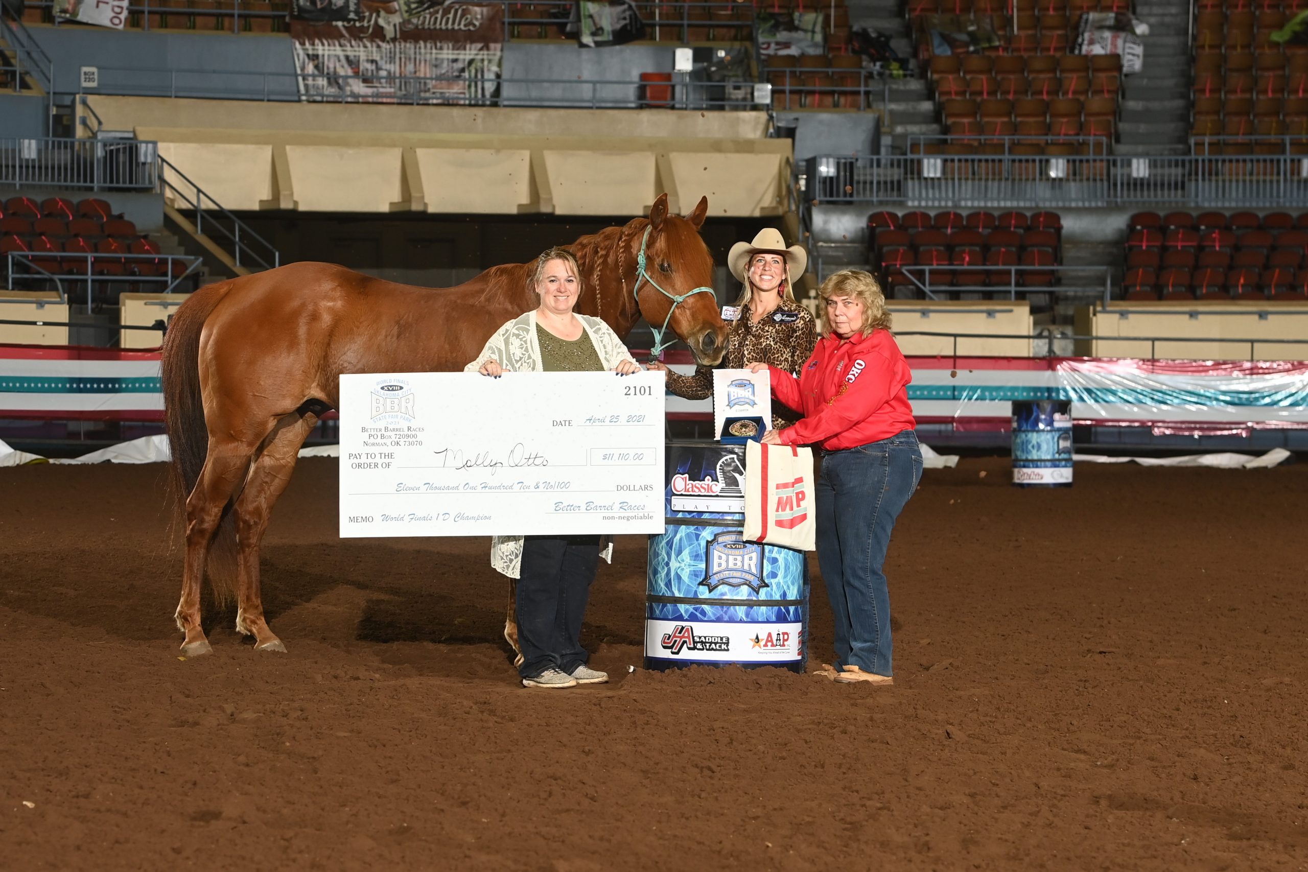 Molly Otto standing with horse Sixappeal and winners check