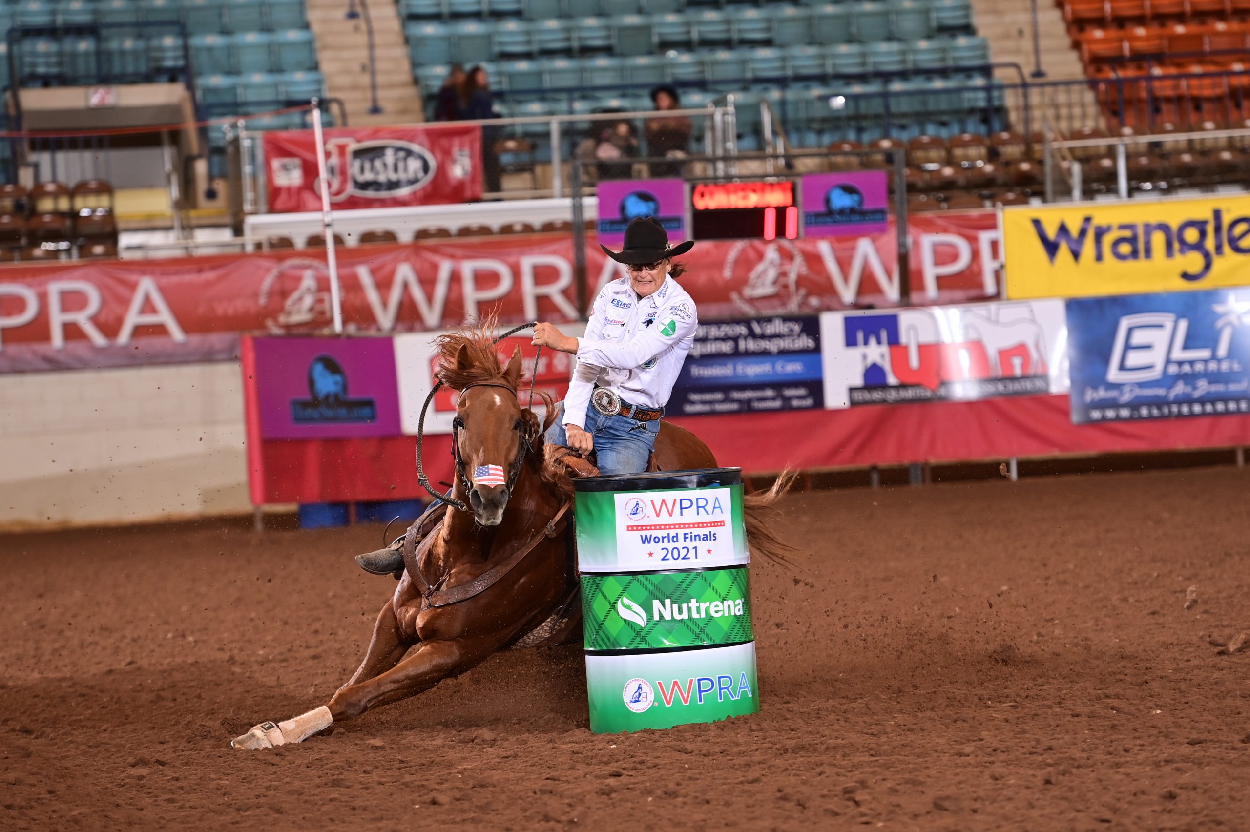 Dona Kay Rule and High Valor turning around a barrel