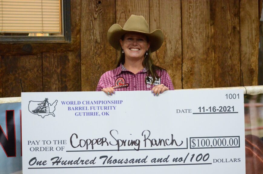 Leslie Willis holding a big check