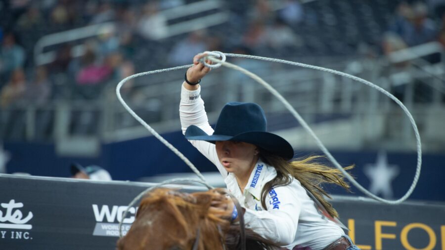 girl swinging rope at rodeo
