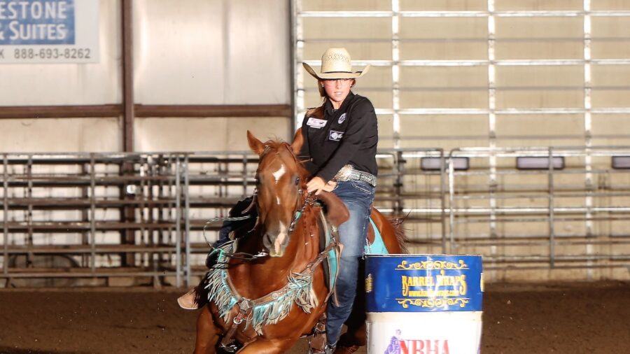 girl turns barrel on horse