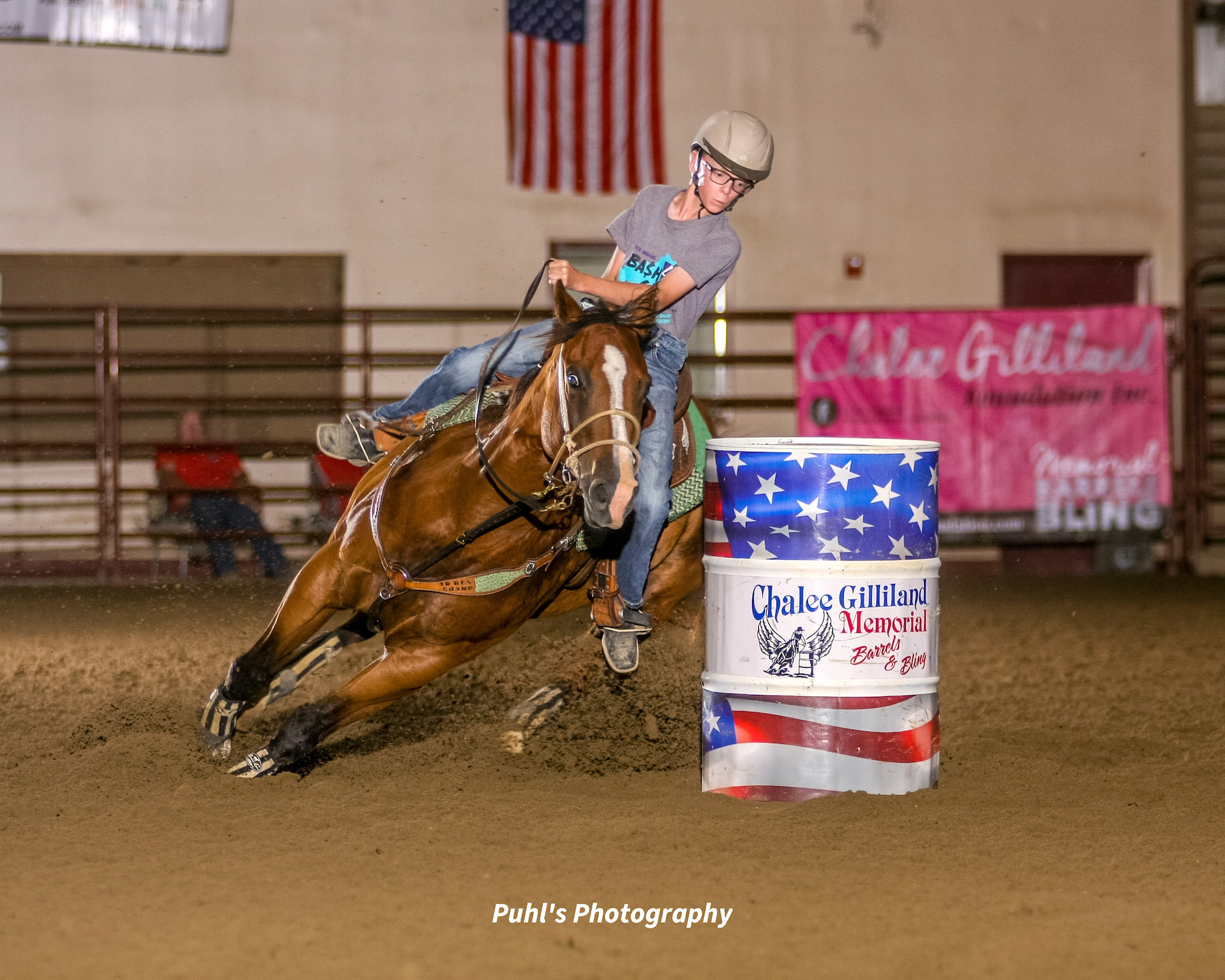 boy turns a barrel on his horse