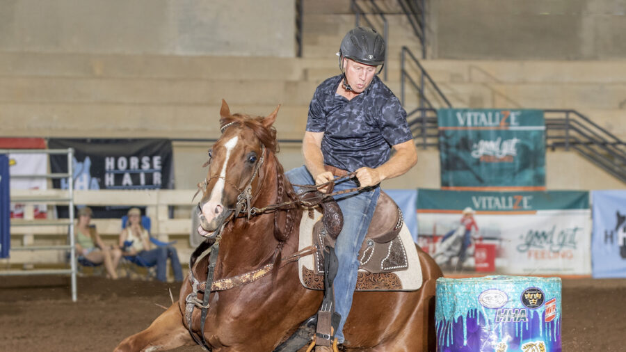 man turns barrel on horse