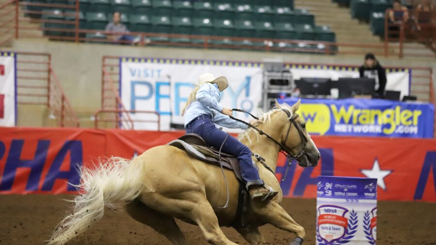 barrel racer on palomino horse
