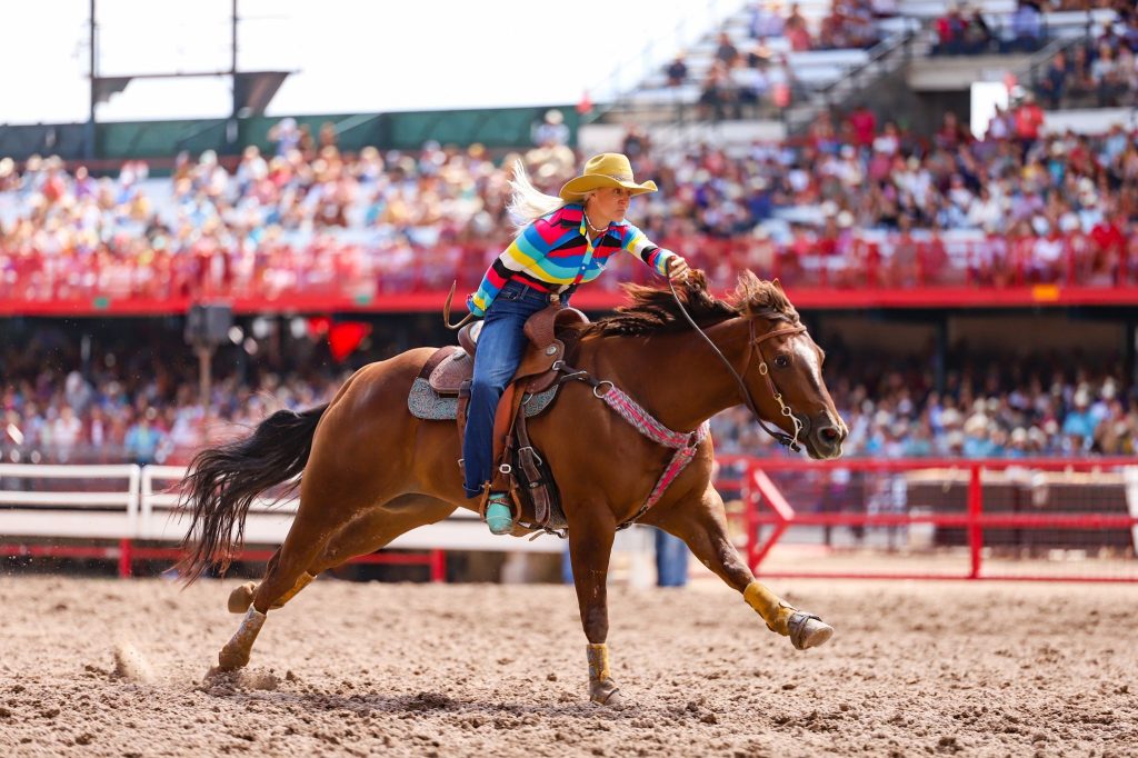 girl running home on sorrel horse at Cheyenne Rodeo