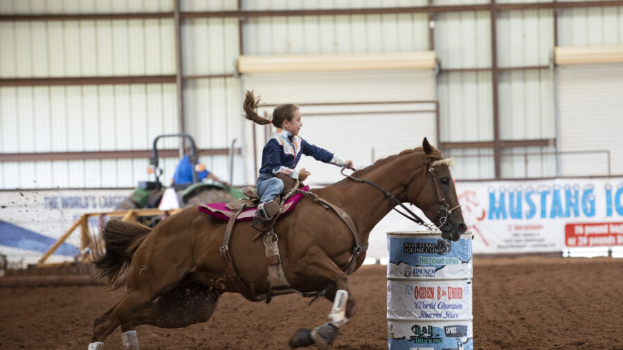 Dusky Lynn Hall turns barrel on horse
