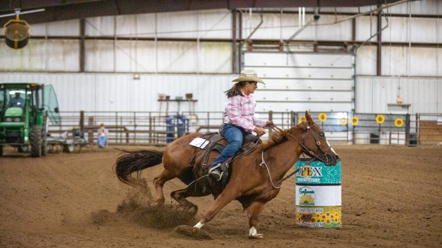 Diane Axmann turns barrel on horse.