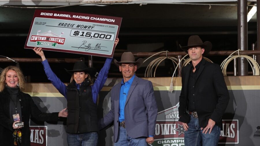 Kassie Mowry with winner's check at Cowtown Christmas Championship Rodeo