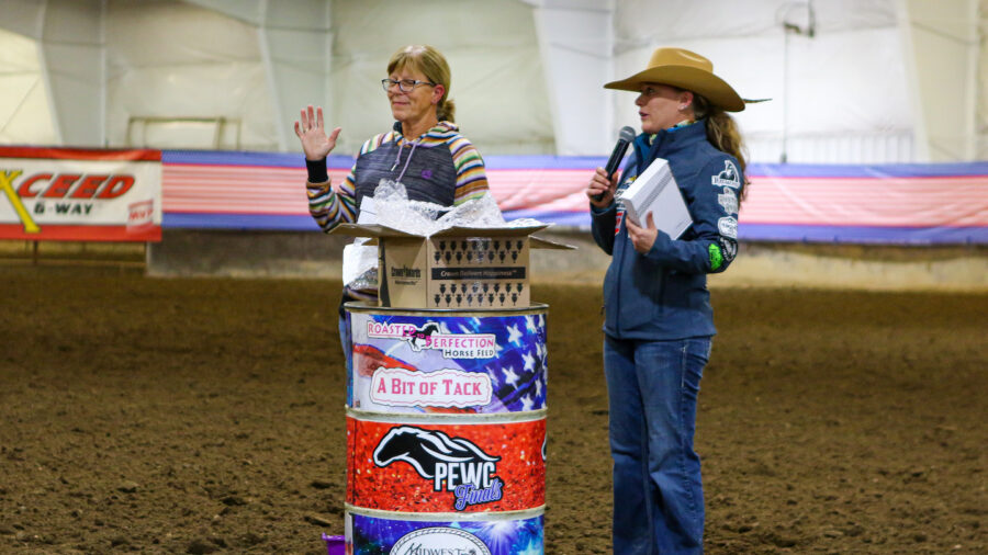 Amber Webber and Verna Hultman present awards at PEWC Finals barrel race.