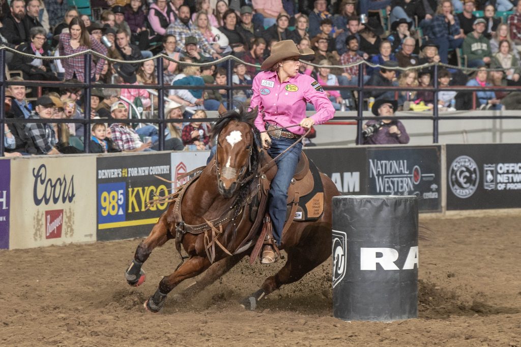 Jamie Olsen turns a barrel at the Denver rodeo