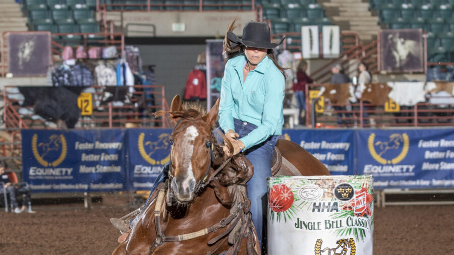 Ryann Pedone turns barrel on horse.
