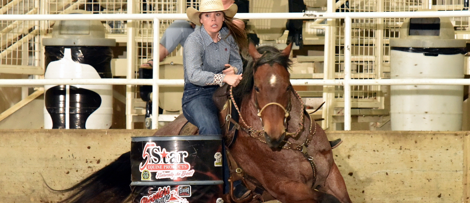 Hailey Kilgore turns a barrel on Sophie Goldseeker at the Lucky Dog race.