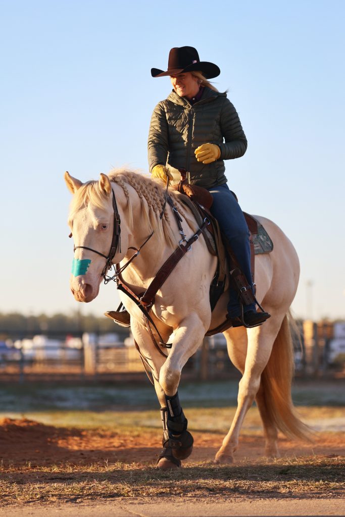 barrel racer warming up her horse