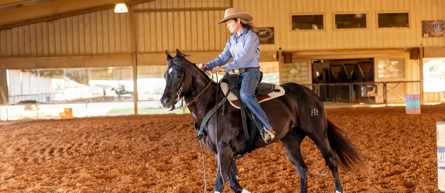 Trainer Caroline Boucher on a horse. Photography by Abigail Boatwright