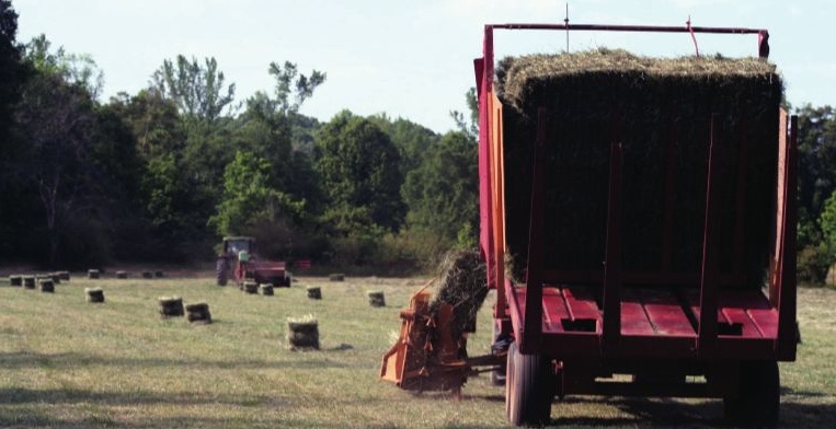 photo of a hay baler doing its job