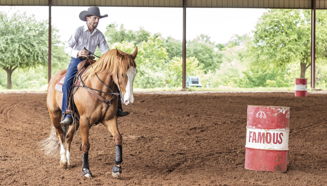 Depending on your horse's energy level, about 15-30 feet from the barrel, sit down in your seat and ask your horse to collect and slow down to a trot or walk. Do not pull it into a stop.