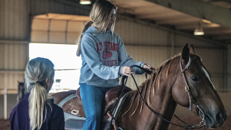 Charmayne helping a novice rider with her points around the turn
